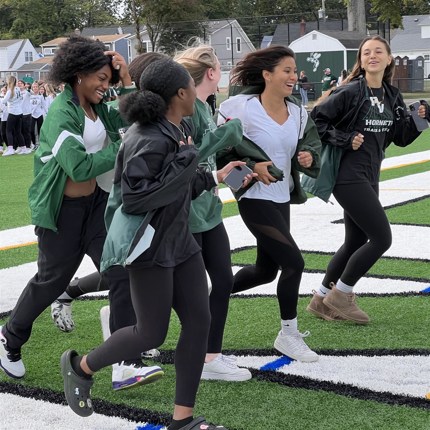  Girls Soccer running out onto the new turf field; photo credit: Rae Allex